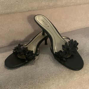 Unisa slip on shoe with kitten heel and flower straps.